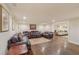 Finished basement area with leather sofas, rug, and hardwood floors at 9865 Buice Rd, Alpharetta, GA 30022