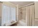 Bright bathroom featuring a shower with tile surround and a bench by the window at 9865 Buice Rd, Alpharetta, GA 30022