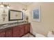 Elegant half bath with marble countertop, decorative mirror, and stylish fixtures at 9865 Buice Rd, Alpharetta, GA 30022