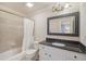 Neutral bathroom featuring a shower with tile surround and a granite countertop at 9865 Buice Rd, Alpharetta, GA 30022