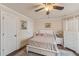 This bedroom features a ceiling fan and a dresser with a picture at 9865 Buice Rd, Alpharetta, GA 30022