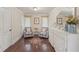 Relaxing bedroom with hardwood floors, a large dresser, and striped armchairs at 9865 Buice Rd, Alpharetta, GA 30022