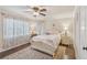 Cozy bedroom featuring large bed and a ceiling fan and large windows in a neutral palette at 9865 Buice Rd, Alpharetta, GA 30022