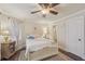 Cozy bedroom featuring large bed and a ceiling fan and large windows in a neutral palette at 9865 Buice Rd, Alpharetta, GA 30022