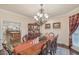 Elegant dining room with hardwood floors, chandelier, and view to the kitchen at 9865 Buice Rd, Alpharetta, GA 30022