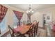 Dining room featuring a wood table, chandelier, and natural light at 9865 Buice Rd, Alpharetta, GA 30022