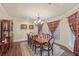 Formal dining room with chandelier, wood table, and decorative curtains at 9865 Buice Rd, Alpharetta, GA 30022