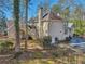 Back exterior of home with lush landscape and partially covered pool at 9865 Buice Rd, Alpharetta, GA 30022