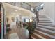 Grand foyer with hardwood floors, staircase, and view of the living area at 9865 Buice Rd, Alpharetta, GA 30022