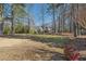 Well-manicured front yard with mature trees offering a sense of tranquility at 9865 Buice Rd, Alpharetta, GA 30022