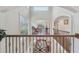 Bright hallway featuring decorative railing and a view of the living area in a neutral palette at 9865 Buice Rd, Alpharetta, GA 30022