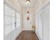 Bright hallway with natural light, hardwood floors, and a decorative floral arrangement at 9865 Buice Rd, Alpharetta, GA 30022