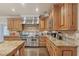 Well-equipped kitchen featuring stainless steel appliances, granite countertops, and custom wood cabinetry at 9865 Buice Rd, Alpharetta, GA 30022