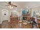 Cozy living room with a stone fireplace, built-in shelving, and views of the backyard at 9865 Buice Rd, Alpharetta, GA 30022