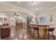 Cozy living room with a stone fireplace, built-in shelving, and views of the backyard at 9865 Buice Rd, Alpharetta, GA 30022