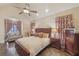 Comfortable main bedroom showcasing hardwood floors, a ceiling fan, and natural light at 9865 Buice Rd, Alpharetta, GA 30022