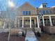 Attractive brick-front townhome features a covered entrance with sturdy columns and wrought iron railings on a landscaped lot at 1055 Dryden Ln # 10, Atlanta, GA 30319