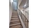 Staircase with wood and white risers and black metal balusters and handrail lead to the next level at 1055 Dryden Ln # 10, Atlanta, GA 30319