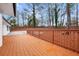 Fenced backyard features wooden deck overlooking landscaped yard and mature trees at 2670 Thornbury Way, Atlanta, GA 30349