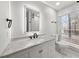 Modern bathroom featuring granite countertop, bright mirror, and window at 2670 Thornbury Way, Atlanta, GA 30349