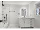 Bathroom features modern vanity, illuminated mirror, and marble tiled shower with modern fixtures at 2670 Thornbury Way, Atlanta, GA 30349