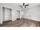 Bright bedroom features hardwood floors, ceiling fan, two closets with shelving and ensuite bath at 2670 Thornbury Way, Atlanta, GA 30349