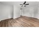 Bedroom featuring new flooring, a ceiling fan, two doors and natural light at 2670 Thornbury Way, Atlanta, GA 30349