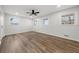 Spacious bedroom featuring hardwood floors, a ceiling fan, three windows, and neutral paint at 2670 Thornbury Way, Atlanta, GA 30349