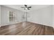 Bright bedroom featuring hardwood floors, white walls, ceiling fan, and natural light at 2670 Thornbury Way, Atlanta, GA 30349