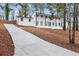 Side view of a white brick home with a new driveway and landscaping at 2670 Thornbury Way, Atlanta, GA 30349