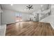 Open living room featuring new flooring, a fireplace, ceiling fan, and natural light at 2670 Thornbury Way, Atlanta, GA 30349