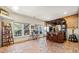 Basement bar area with hardwood floors and brick accents at 3015 Woodvale Ct, Alpharetta, GA 30022