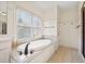 Bathroom with a large soaking tub and tiled floor at 3015 Woodvale Ct, Alpharetta, GA 30022