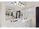 Bright bathroom featuring white cabinetry, double sinks, and modern lighting at 3015 Woodvale Ct, Alpharetta, GA 30022