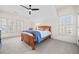 Bright bedroom with shuttered windows and a ceiling fan at 3015 Woodvale Ct, Alpharetta, GA 30022