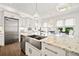 Bright kitchen featuring stainless steel appliances, a large island, and a beautiful farmhouse sink at 3015 Woodvale Ct, Alpharetta, GA 30022