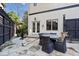 A lovely outdoor patio features stone floors, a dining table, and a dark-stained privacy fence at 3015 Woodvale Ct, Alpharetta, GA 30022