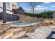 Beautiful in-ground pool features stone surround and a stone retaining wall at 3015 Woodvale Ct, Alpharetta, GA 30022