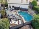 Aerial view of a backyard with a pool, stone patio, pergola, and landscaped surroundings at 3015 Woodvale Ct, Alpharetta, GA 30022