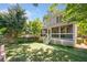 Beautiful backyard featuring a well-maintained lawn, mature trees, and screened-in porch, creating a serene outdoor space at 3232 Cates Ne Ave, Brookhaven, GA 30319