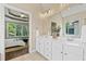 Bathroom features a double vanity, large mirror, and views into the main bedroom at 3232 Cates Ne Ave, Brookhaven, GA 30319