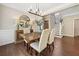 Well-lit dining area with modern chandelier, hardwood floors, and staircase access at 3232 Cates Ne Ave, Brookhaven, GA 30319