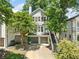 Charming home exterior with two-car garage, lush landscaping, and inviting stairway to upper level at 3232 Cates Ne Ave, Brookhaven, GA 30319