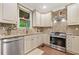 Charming kitchen featuring stainless steel appliances, granite countertops, and warm cabinetry at 3232 Cates Ne Ave, Brookhaven, GA 30319