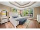 Bright main bedroom features a tray ceiling and backyard view at 3232 Cates Ne Ave, Brookhaven, GA 30319