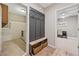 Mudroom with coat rack, bench, and storage baskets, with laundry room and office visible through doorways at 3232 Cates Ne Ave, Brookhaven, GA 30319