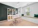 Home office space featuring built-in desk, window seating and green accent wall at 3232 Cates Ne Ave, Brookhaven, GA 30319