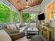 Comfortable screened porch with wood plank ceiling and fan at 3232 Cates Ne Ave, Brookhaven, GA 30319