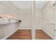 A walk-in closet with built in shelving and hardwood flooring at 3232 Cates Ne Ave, Brookhaven, GA 30319