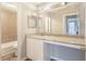 Bathroom vanity with granite counter, mirror, and light-tile bath at 602 Granville Ct, Sandy Springs, GA 30328